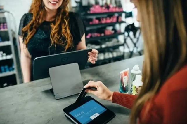 Healthcare professional using laptop with stethoscope laying on desk